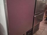 a purple refrigerator sitting in a kitchen next to a stove