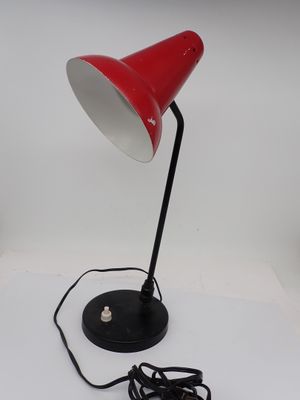 an image of a red table lamp with a cord plugged into it