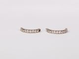 a pair of diamond earrings on a white background