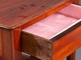 a wooden table with a drawer on top of it