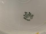 the bottom of a white plate with a crown on it