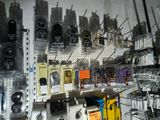many different types of cell phones hanging on the wall