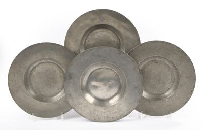 three silver plates are stacked on top of each other on a white surface