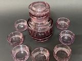 a lot of pink glass cups on the table