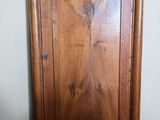 a wooden cabinet with a mirror on top of it