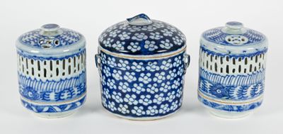 three blue and white jars sitting next to each other