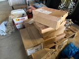 a pile of boxes sitting on top of a wooden pallet