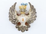 a bird with a crown on it ' s head on a wall