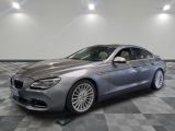 the bmw 6 series grano is parked in a showroom