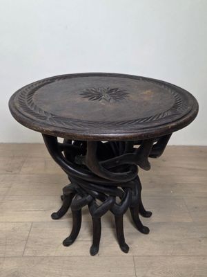 an image of a wooden table with a metal base on a wooden floor