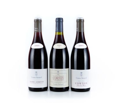 trois bouteilles de vin sont alignées sur une surface blanche