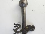 a metal sword with a dragon on it on a white surface