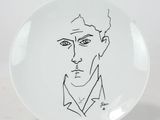 a plate with a drawing of a man ' s face on it