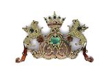 une image représentant une broche surmontée d'une couronne