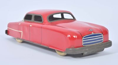 a red toy car that is sitting on a white surface