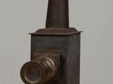 a small stove sitting on top of a wooden table
