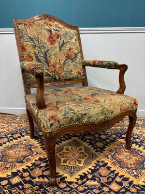 an old chair with a floral upholstered seat