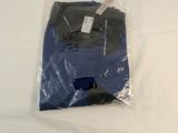 the shirt is in a plastic bag on a white surface
