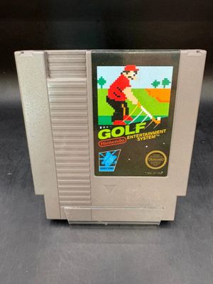 an old nintendo golf game is displayed on a table