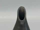 an image of a black vase on a white surface