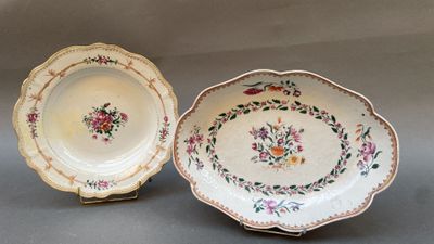 two plates with floral designs on them are sitting on a table
