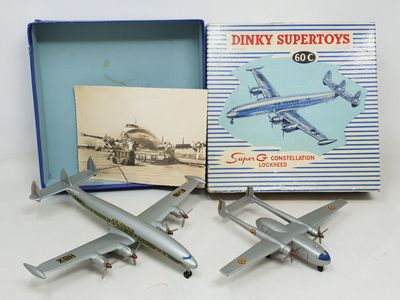 two model airplanes are sitting in a box on a white surface