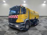 a large yellow truck that is parked in a room