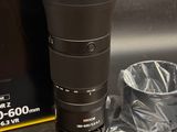 a camera lens sitting on a table next to a bag