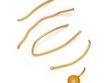 a set of five gold plated hair pins and a ball