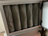 a small refrigerator with a lot of bags inside of it