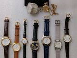 a lot of watches that are sitting on a display stand
