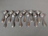 six spoons are arranged in a row on a table