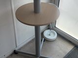 a table with two small tables on it in front of a window