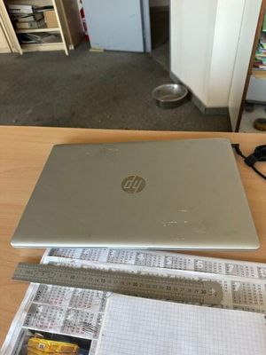 a laptop computer sitting on a table with papers and pencils