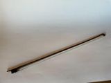 a long stick that is laying on a piece of paper