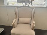 a chair in the corner of a room with a poster on the wall