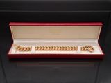 an image of a gold bracelet and cuff set in a red box