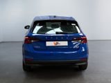 the rear end of a blue volvo v - pace parked in a white room