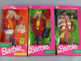 three barbie dolls are in their boxes on a table