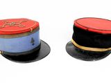 two hats on top of each other on a white surface