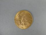 l'image d'une pièce d'or sur laquelle figure une femme