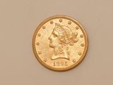 a close up of a gold coin with a woman ' s head on it