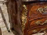 a marble top chest of drawers with a marble top