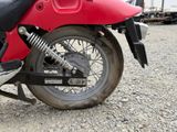 a red motorcycle that is parked on the side of the road