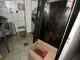 a black refrigerator in a kitchen with a box in the middle of it