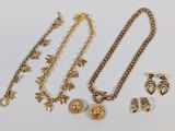 a close up of a bunch of jewelry on a white surface