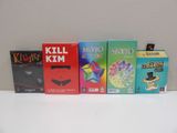 four boxes of games sitting on a white table