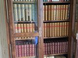 a book case with many books on it in a room