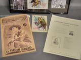 three framed movie posters are on display on a table