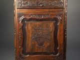 an old wooden cabinet with a carved design on the front